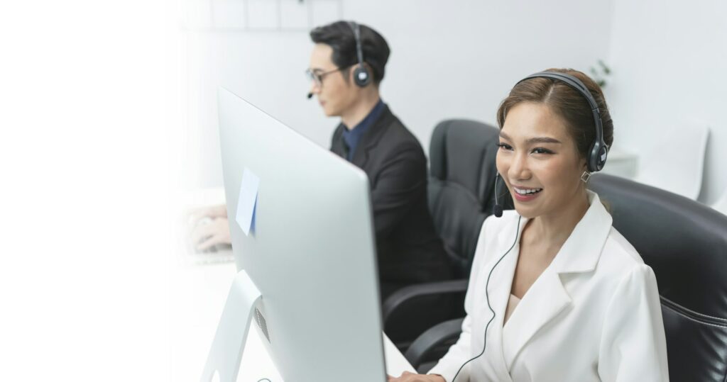 Asian call center agent team, customer service support wearing headset talking with customer